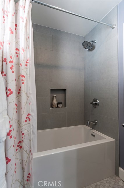 The hall bath includes a contemporary soak tub.