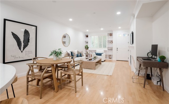 Custom shelving around beautiful picture window overlooking porch and landscaped walkway.  Notice the easy alcove for home office or study area off of the dining area.