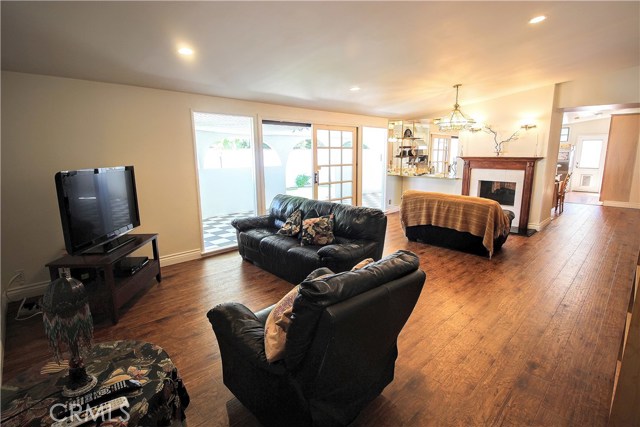 Before virtual staging, same room--easy to see the difference that can be made to this huge living area with fireplace that warms both the living and dining rooms.