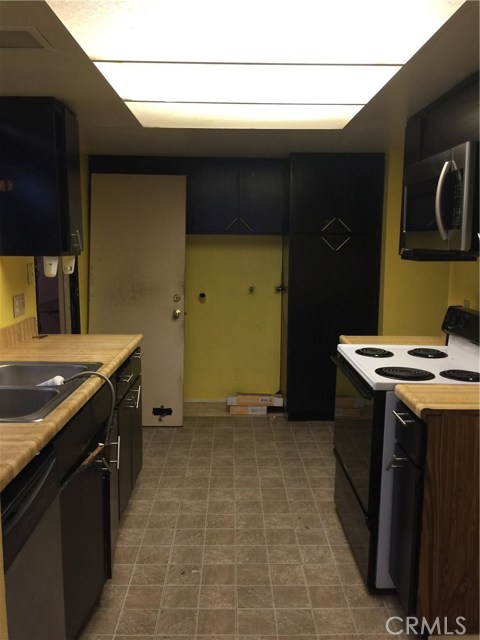 Kitchen looking back at garage door entrance. Washer/Dryer hookups