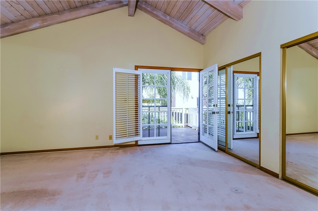 The master bedroom has a wall of closets and an adjoining private deck