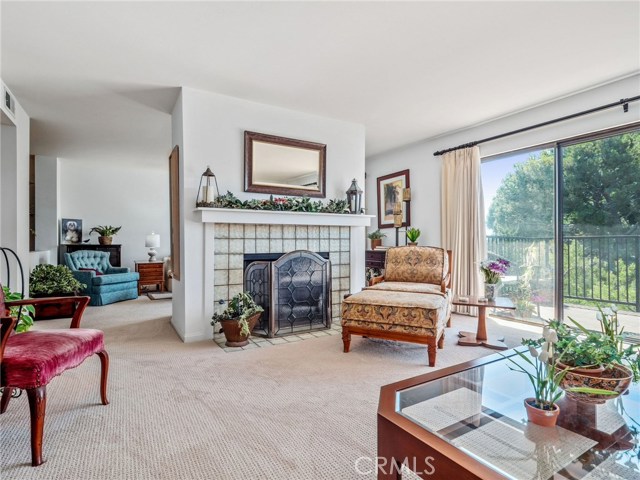 Living room with fireplace open to adjacent den