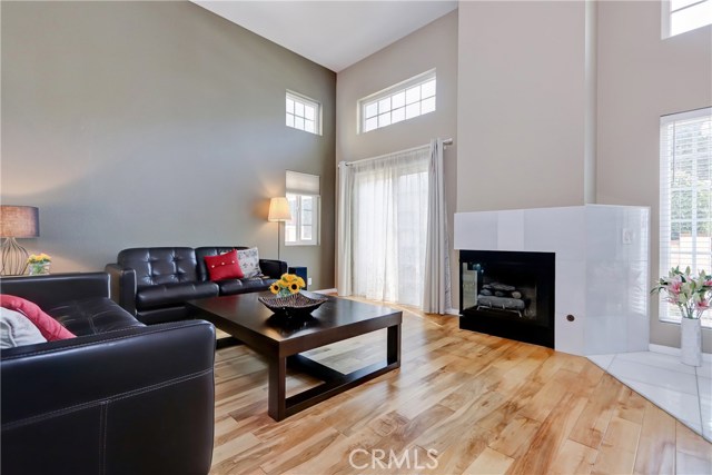 Ideal for family and friends this living room features a floor to ceiling fireplace and overlooks gated patio!