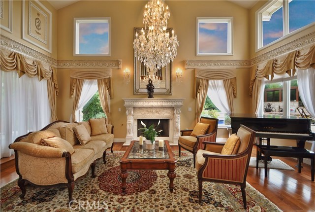 living room with wood floors, large beautiful Chandeliers.