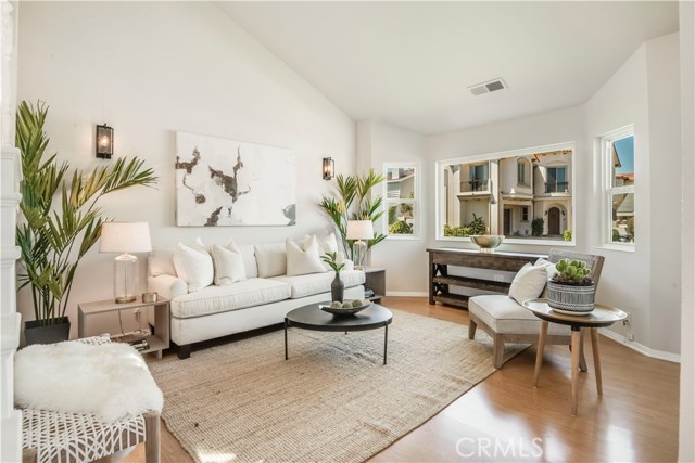 Inviting living room with soaring ceilings and a bay window.