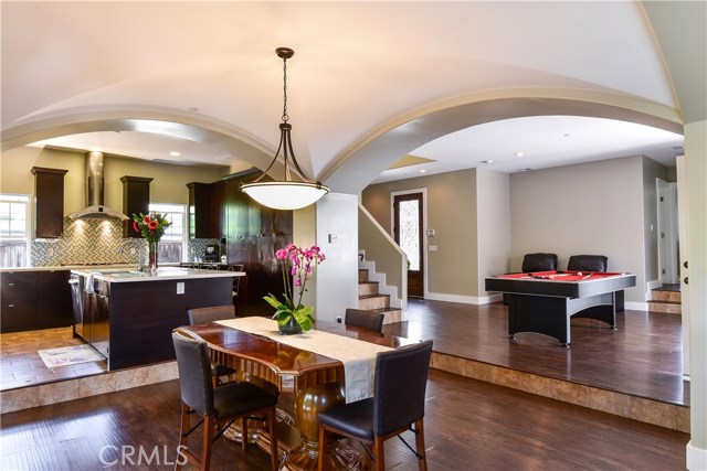 Open living space with beautiful arched ceiling defining the dining area, high ceilings throughout
