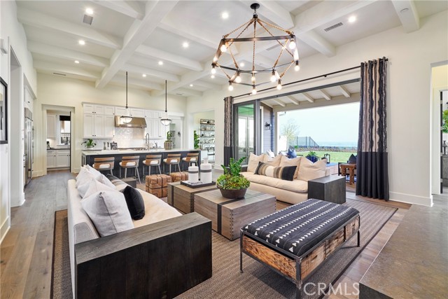 Great room & kitchen, opening onto the back yard & city lights views.