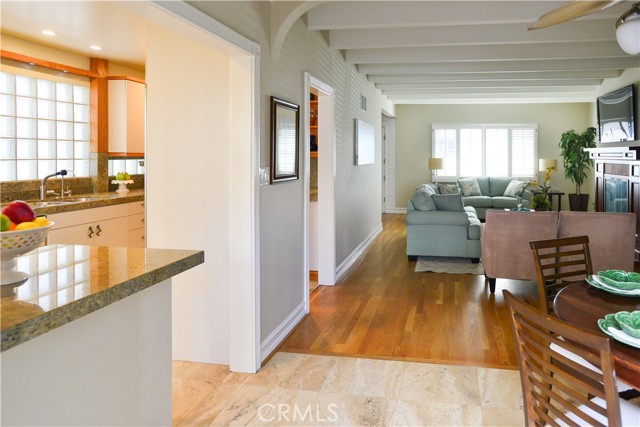 Perspective of Kitchen, Dining and Living Room. Notice the glass bricks in the kitchen, they are from the original construction of this home.