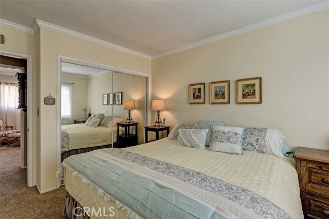 3rd Bedroom with smooth ceilings, carpet and crown molding.