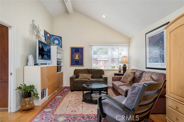 Master bedroom is currently used as a family room. This room faces backyard and has vaulted ceilings, sunny exposure, its' own bathroom and walk-in closet. Door at left leads to office or den.