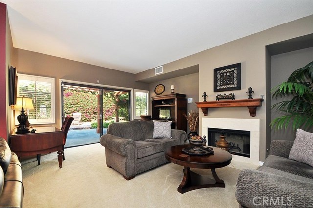 Living room with fireplace and direct access to rear yard