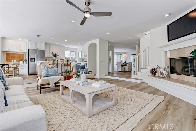 ENTRY LEVEL GREAT ROOM AREA WITH TRAVERTINE FIREPLACE SURROUND AND RAISED HEARTH