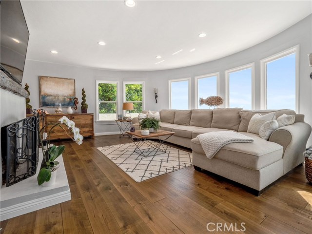 Spacious living room - gorgeous wood floors, windows overlook the stunning view!