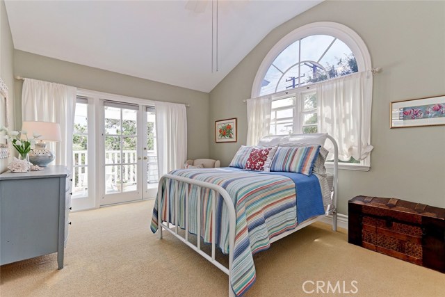 Upstairs guest bedroom with spacious outdoor deck.