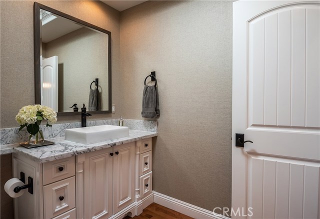 Main floor powder room featuring Carrara marble, wall paper, beautiful finishes!