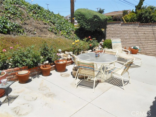 Another Angle that continues to Show the Privacy of the Yard from Neighbors with Lush Hillside and Block Wall.