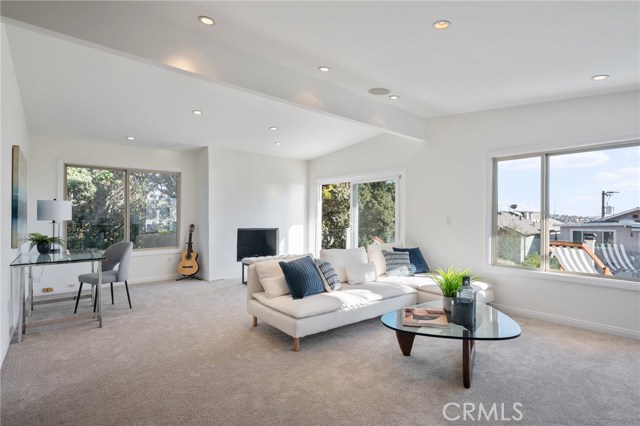Big upstairs family room with fireplace, door to the view balcony and incredible natural light.