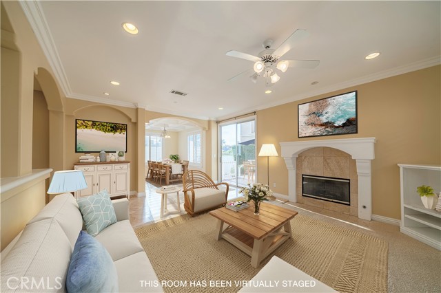 Living Room with fireplace, view to dining area, outdoor deck and patio