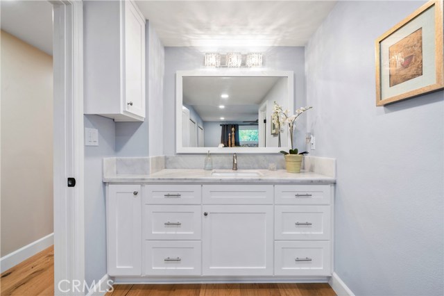 The master bedroom private vanity with marble countertops, custom shaker style cabinets and gorgeous crystal light fixture.