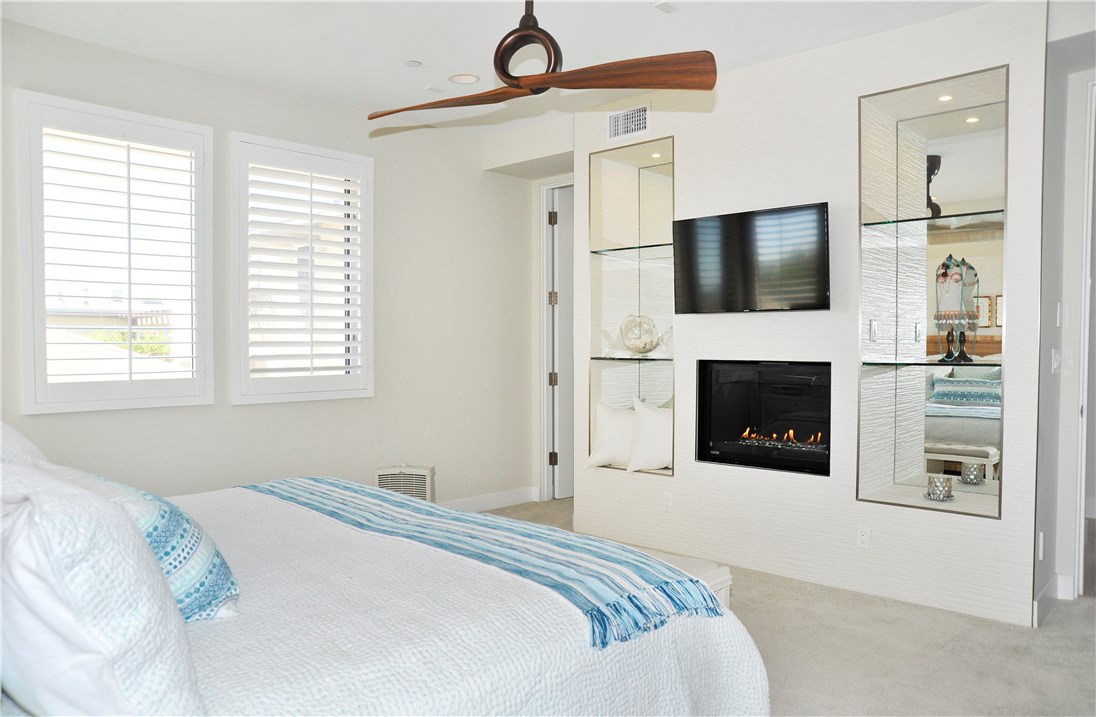 Master bedroom has walk in closet, fireplace, plantation shutters, built in shelves, ceiling fan