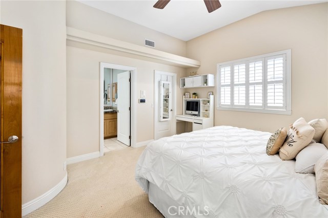 Master bedroom with high ceilings and ceiling fan