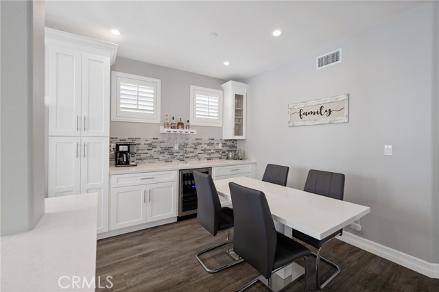 dining area with additional cabinetry, bar area, and wine fridge dining area with additional cabinetry, bar area, and wine fridge