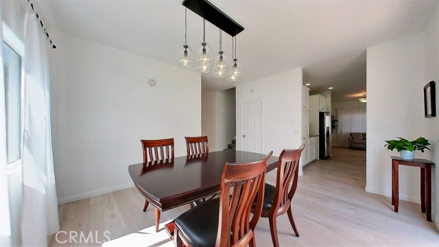 Plenty of natural light coming in from the window into the formal dining room with beautiful hanging lights over the dining area to illuminate the area during the evening. The formal dining room has an easy access to the outdoors for a more casual and relaxing morning coffee and breakfast on the patio outdoors.