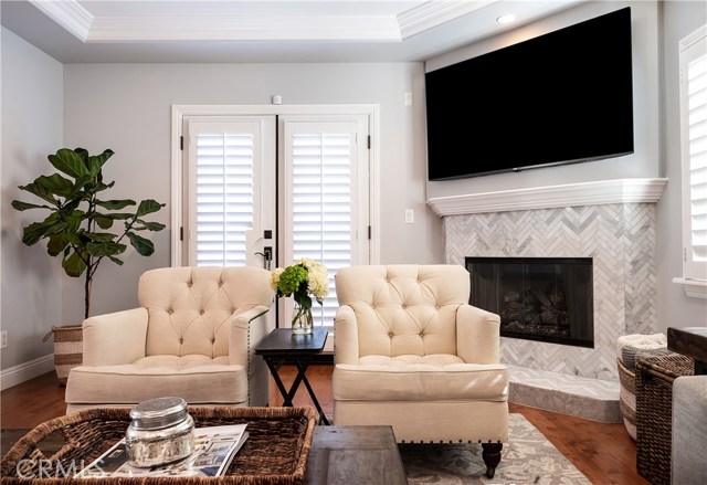 Beach sophistication at its best! Carrara marble, herringbone tile fireplace in family room.