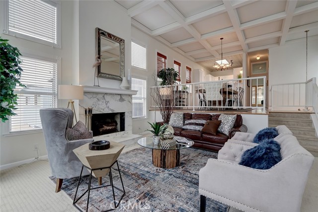 Living room area with an open view of dining and kitchen area.
