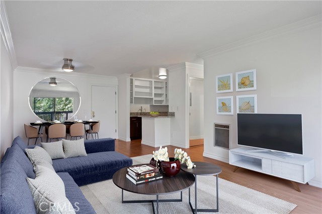 Virtually staged living and dining area with open kitchen.