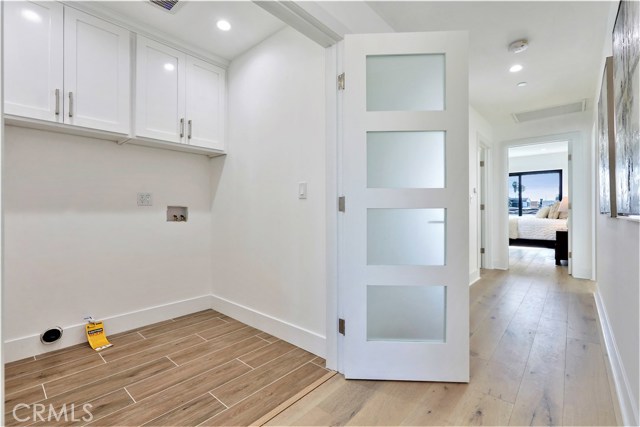 There is a Large Centrally Located Laundry Room with Storage Cabinets on The Upper Level