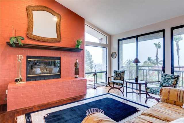 The family room includes brick fireplace and access to a terrace where you can enjoy the sunset or catalina views.