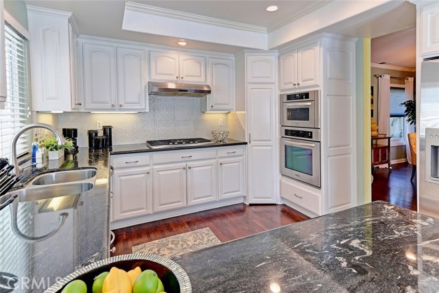 Kitchen Area with Granite Countertops and Stainless Steel Appliances