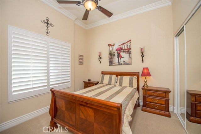 Bedroom #4 with Plantation Shutters, Ceiling Fan and Mirrored Closet Doors.