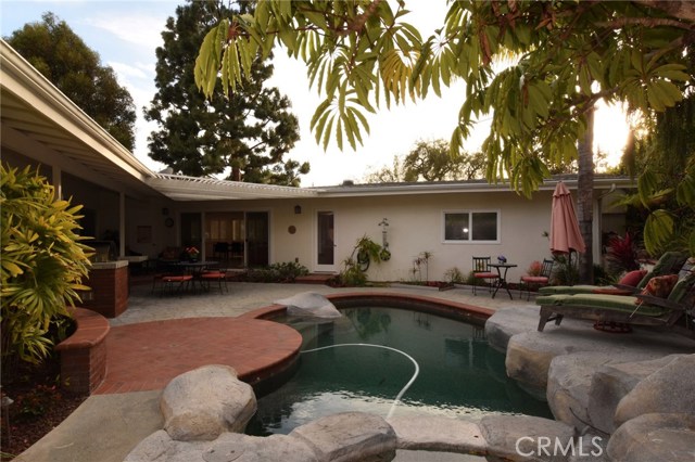 More tropical pool view, with another patio beyond, and slider opening to the family room/kitchen!