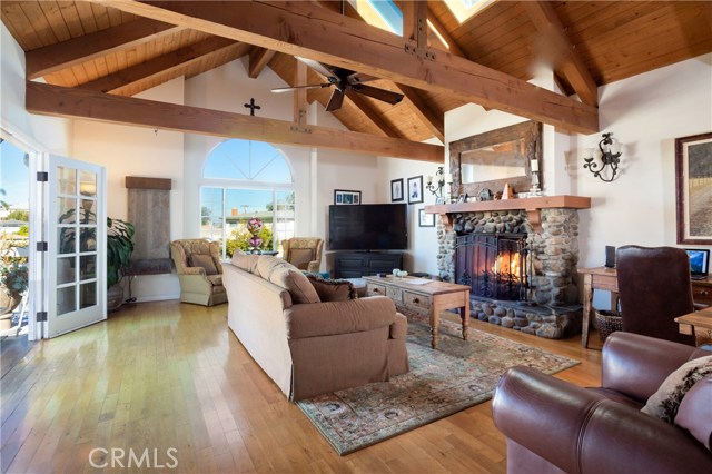Fabulous Living Space with Wood Beam Ceiling and Fireplace. French Doors to Outdoor Balcony.
