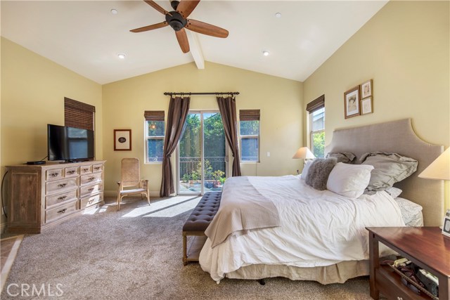 Beautiful master suite with vaulted ceilings, recessed lights, walk in closet and sliders to the balcony