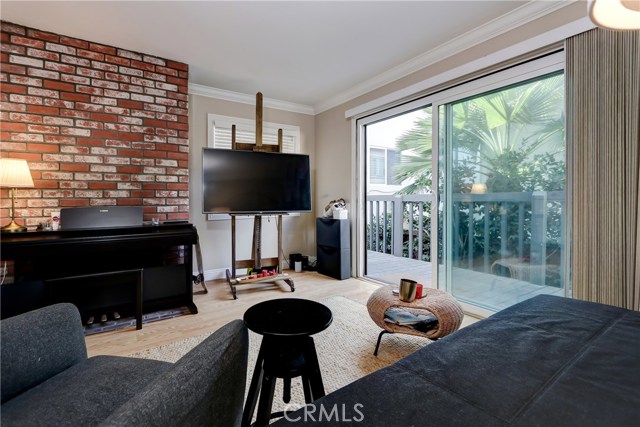 The downstairs one bedroom and one bath also has it's own deck plus a charming fireplace (behind the piano!)