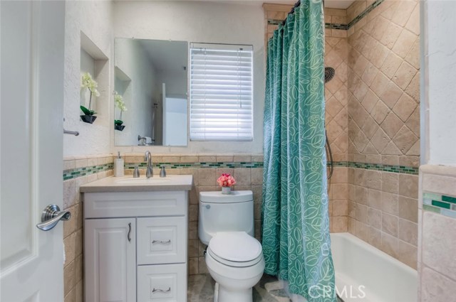 The full bath upstairs is remodeled with warm colors and accent tile for a splash of color.