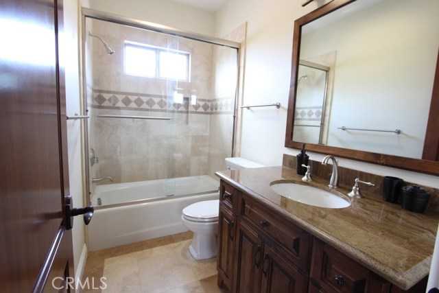 Full bath upstairs, granite, marble, travertine, wood accents.