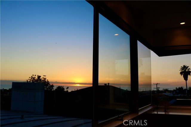 Sunset from living room. Great views from Dining room, decks and a peek from Master.