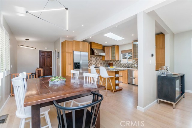 Light and elegant modern lighting fixtures elevate the dining area and staircase down to lower level.
