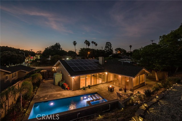 Night view of pool, home, lounge and cabana areas