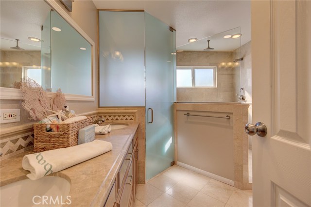 Spacious Master Bathroom comes with private toilet and stylish custom cabinetry