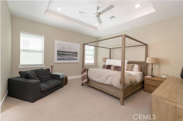 Grand master suite  with soaring ceilings, designer ceiling fan and lots of natural light