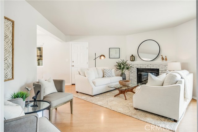 Cheery family room with whitewashed brick, gas fireplace and access to the garage.