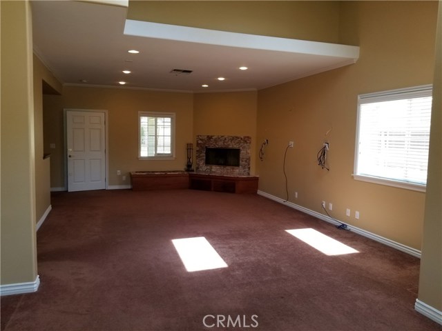 Living area with fireplace, recessed lighting and skylights.