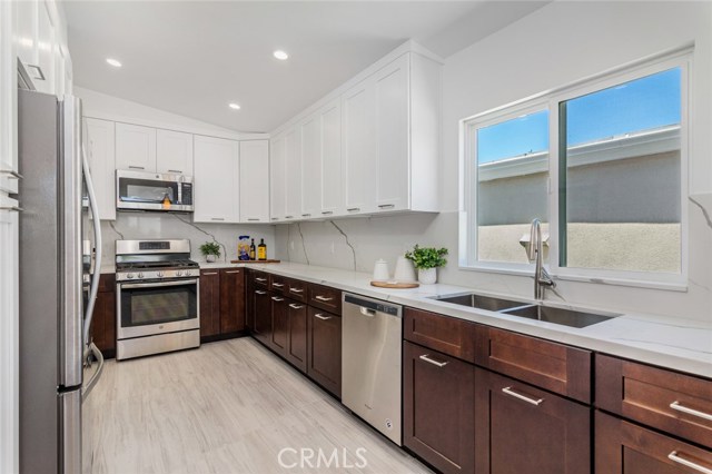 All new stainless steel appliances and a double sink.