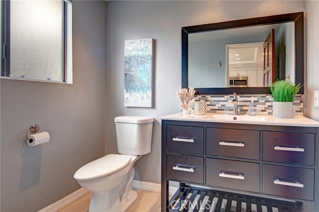 Main level powder room, adjacent to kitchen. Modern vanity, stunning tile backsplash. Main level powder room, adjacent to kitchen. Modern vanity, stunning tile backsplash.