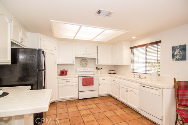 KITCHEN WITH LOTS OF CABINETS AND PANTRY.